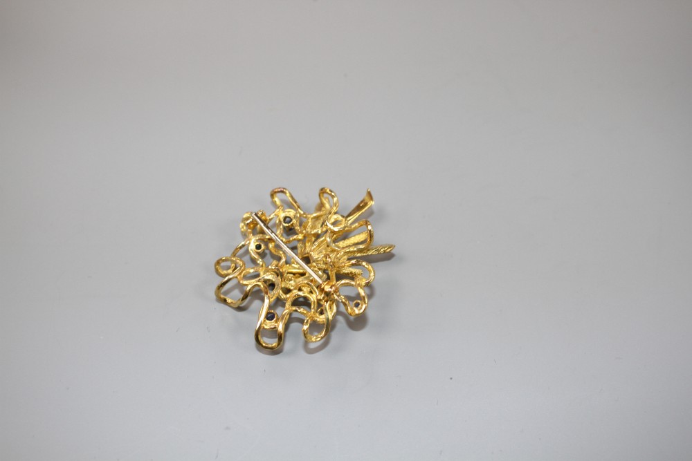 A 1970s? unmarked yellow metal and six stone sapphire set modernist scroll brooch, 46mm, gross weight 17.5 grams.